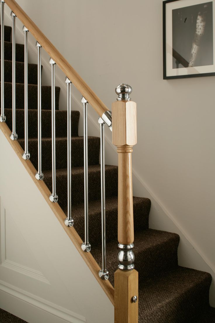 a stair rail on the side of a set of stairs next to a framed photograph