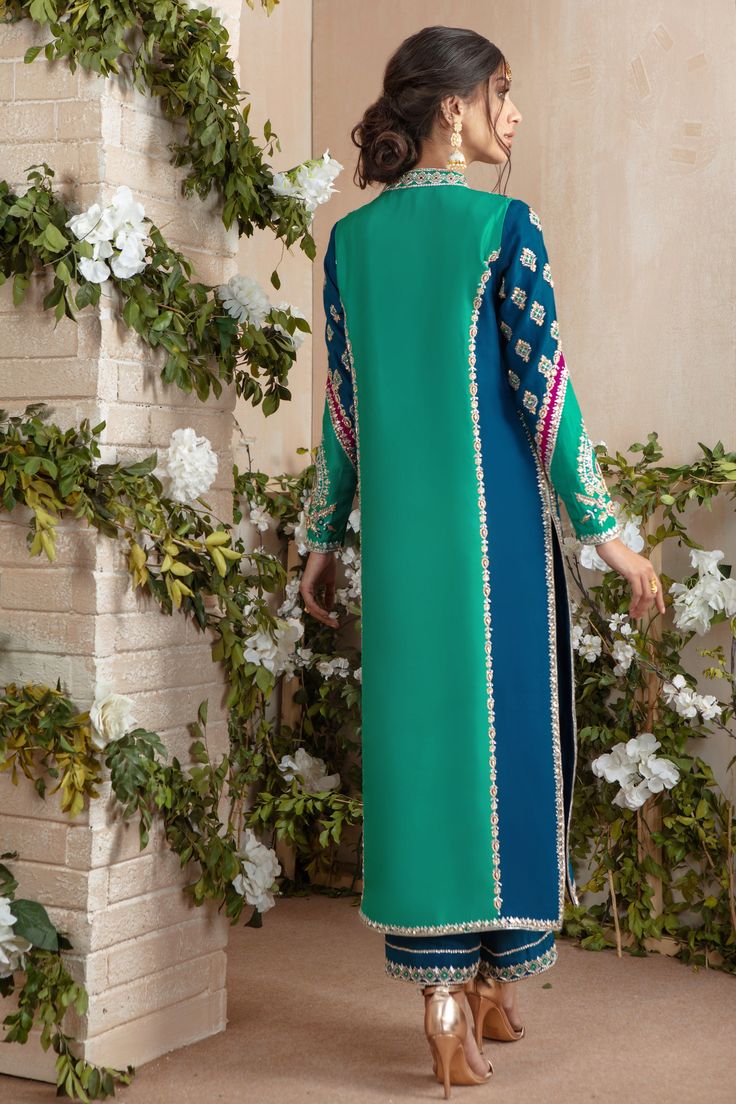 Classy & Stylish, our gorgeous color Block handcrafted Raw silk Jacket, featuring zardozi details in silver & gold dabka, kora, beads, pearls, glistening sequins, resham & tila embroidery, paired with embellished full length izaar and two tone crushed silk dupatta. Jacket & Culottes Fabric: Pure Raw Silk Jacket Length: 48” (Customisable, mention in order notes) Dupatta Fabric: Pure Medium Silk Shirt Color: Turquoise & Teal Blue Culottes Color: Teal Blue Dupatta Color: Teal Blue & Majenta All out Angharka Style Frock, Angharka Style, Dupatta Jacket, Kurta Pattern, Blue Dupatta, Indian Suit, Fusion Wear, Tandoori Masala, Clothes Embroidery Diy