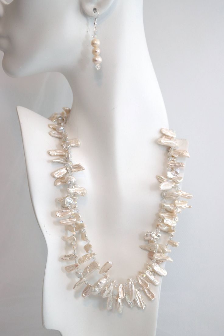 Bold and exquisite, this beautiful necklace is a magnificent statement piece. Two strands of white Biwa freshwater pearls and Swarovski© crystal form the neckline of this alluring accessory. This necklace is adjustable so you can create a look that suits you! White Baroque Pearl Necklace For Party, Elegant Crystal Necklace With Pearl Chain, Silver Pearl Necklace For Formal Occasions, Crystal Pearl Necklace For Party, White Baroque Pearl Jewelry For Party, Elegant Beaded Crystal Pearl Necklace, White Crystal Jewelry With Pearl Charm, Elegant White Single Strand Bridal Necklace, White Pearl Chain Bridal Necklace