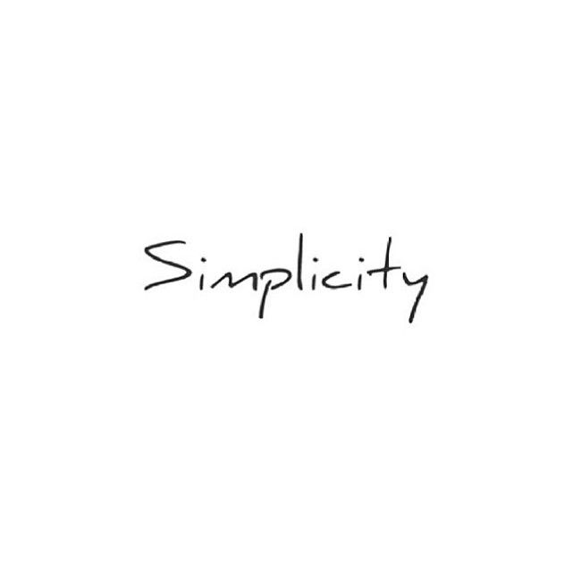 the word simplicity written in black ink