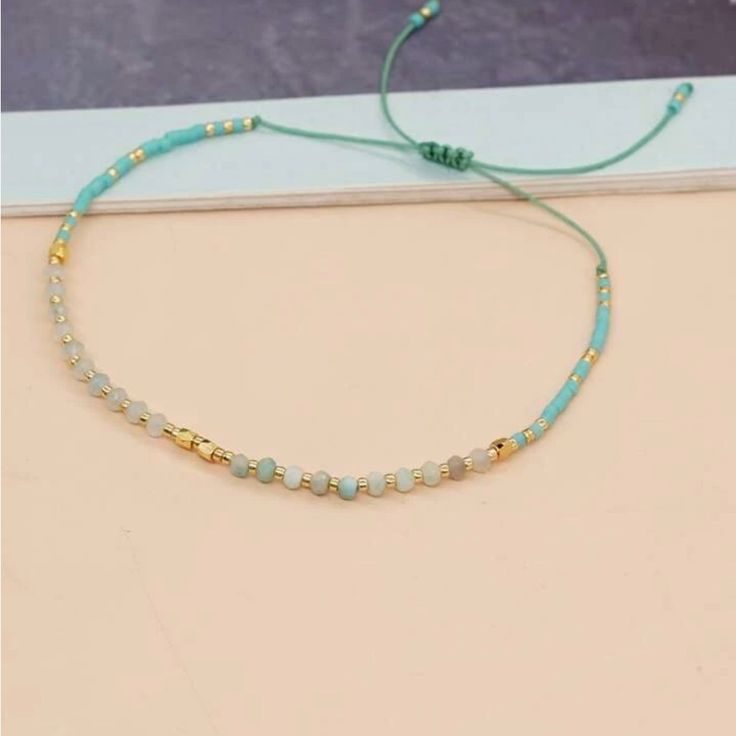 Adjustable Blue / Green Color And Gold Beaded Bracelet. Adjustable Blue Faceted Beads Friendship Bracelets, Adjustable Blue Friendship Bracelets With Faceted Beads, Adjustable Light Blue Beaded Bracelets With Tiny Beads, Trendy Turquoise Friendship Bracelets With Round Beads, Turquoise Friendship Bracelets With Faceted Beads, Trendy Adjustable Blue Crystal Bracelet, Trendy Adjustable Light Blue Bracelet, Light Blue Adjustable Bohemian Beaded Bracelets, Adjustable Light Blue Bohemian Beaded Bracelets