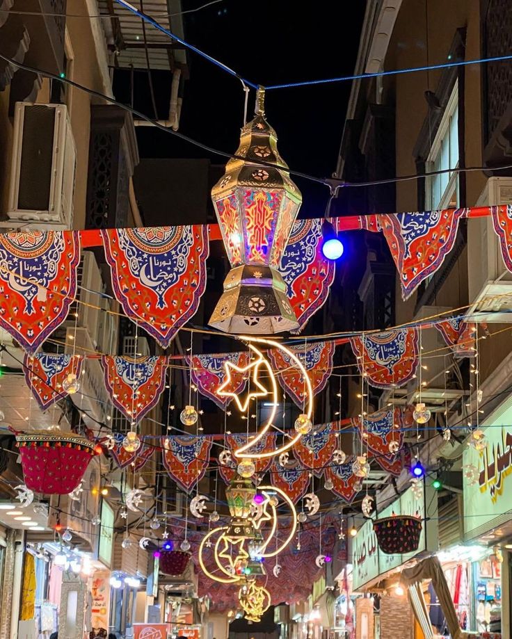 the lights are hanging from the buildings in the street