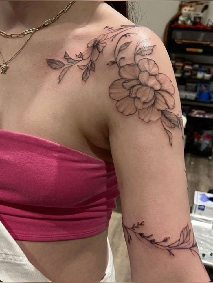 a woman with a flower tattoo on her arm