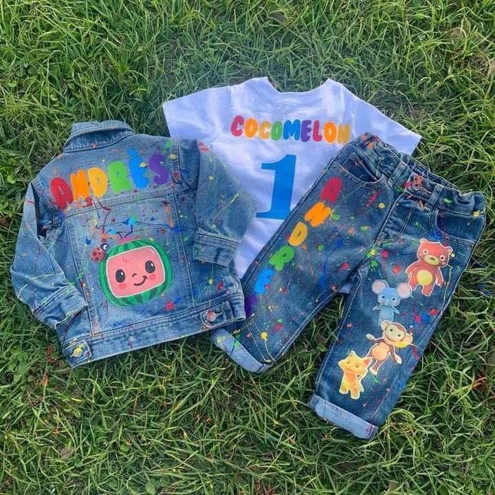 two children's clothing laying on the grass with numbers and animals painted on them