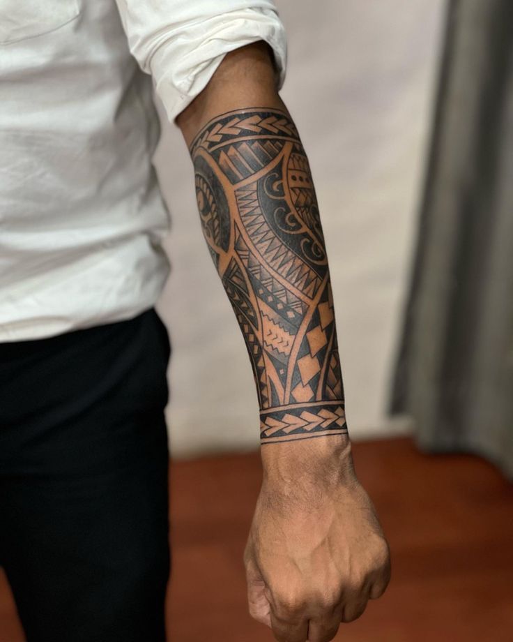 a man with a tattoo on his arm