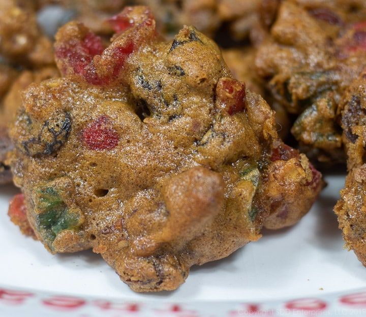 some food on a white plate with red and green trim around the edges that is covered in powdered sugar