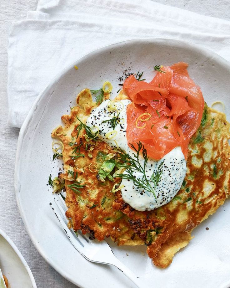 a white plate topped with eggs and salmon