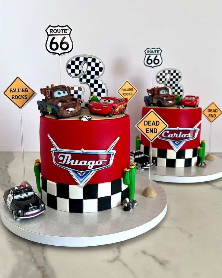 two cakes decorated to look like cars and trucks are on display in front of the cake