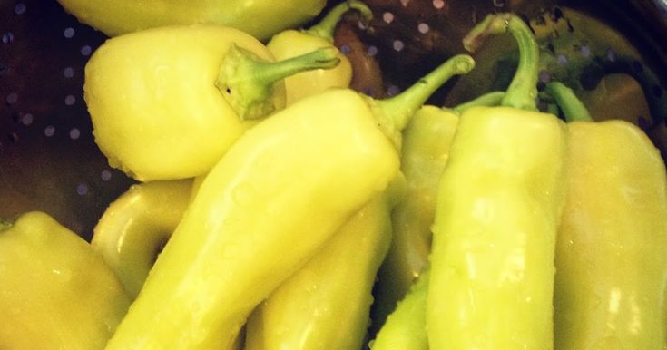 some yellow peppers are in a pot on the stove