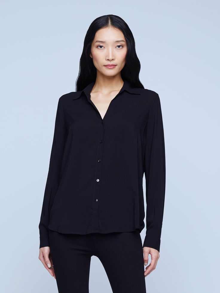 A modern classic. The Nina blouse is structured in all the right places with a relaxed, flattering fit. Refined button-down construction with a chic open collar and draped long sleeve in black silk. Chic Business Casual Blouse With Lapel Collar, Timeless Office Blouse With Lapel Collar, Modern Blouse With Lapel Collar For Office, Viscose Button-up Work Shirt, Versatile Black Blouse For Business Casual, Viscose Button-up Shirt For Work, Chic Business Tops With Lapel Collar, Semi-formal Sleek Blouse With Spread Collar, Sleek Spread Collar Blouse For Work