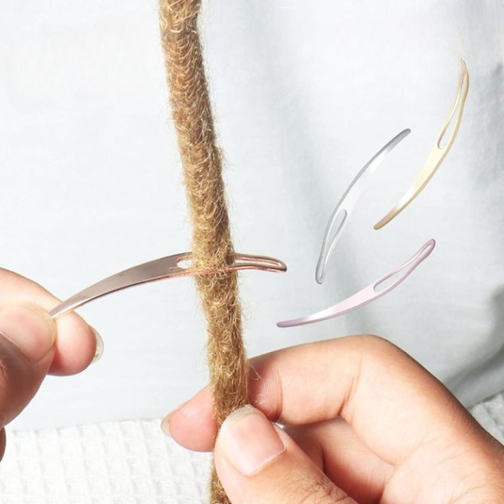 a person is holding scissors over a piece of rope