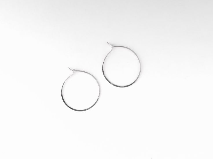 Perfectly dainty, each hoop is formed and hammered by hand giving them just enough of a handmade look. 1" diameter. See also 1.25" Hoops or 1.75" Hoops. Minimalist Hammered Hoop Earrings For Everyday, Handmade Round Hoop Earrings For Everyday, Handmade Everyday Hoop Earrings, Handmade Hoop Earrings For Everyday Wear, Handmade Hoop Earrings For Everyday, Small Hammered Hoop Earrings, Modern Small Hoop Earrings Hand Forged, Nickel Free Open Circle Hoop Earrings For Everyday, Simple Small Adjustable Hoop Earrings