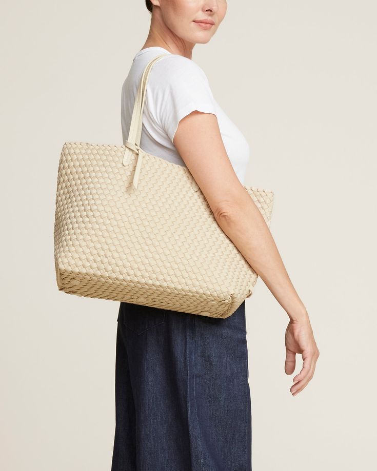 Handwoven neoprene with vegan leather handles in cream. The Jetsetter Small Tote can be carried for travel, work, or baby. Beige Woven Bags For On-the-go, Summer Cream Shoulder Bag For On-the-go, Cream Woven Leather Bag For Daily Use, Neutral Shoulder Bag With Rolled Handles For Travel, Casual Cream Woven Leather Bag, Beige Woven Leather Bag For On-the-go, Cream Summer Shoulder Bag For On-the-go, Cream Woven Leather Bag, Cream Shoulder Bag For Summer On-the-go