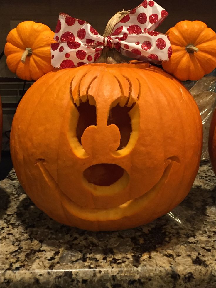 a mickey mouse pumpkin with its face carved into it