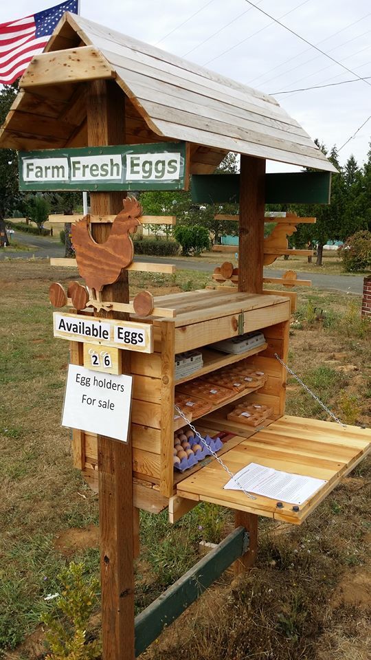 a chicken coop made out of pallets and wood with signs on the side saying, farm fresh eggs