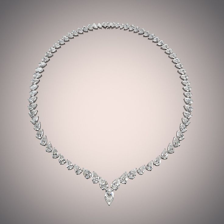 Embody the essence of empowerment with this pear-cut diamond eternity necklace. Designed elegantly with a continuous line of carefully chosen diamonds, each bearing a lovely silhouette similar to a droplet. The pear-cut diamonds gently taper in size as they move to the clasp. Indulgent and remarkable, you can expect a magnificent light performance from this stunning jewel. Pear Cut Diamond Necklace, Eternity Necklace, Pear Cut Diamond, Continuous Line, Teardrop Necklace, Pear Diamond, Diamond Eternity, Custom Engagement Ring, Pear Cut