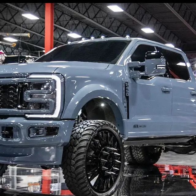 a large blue truck parked in a garage