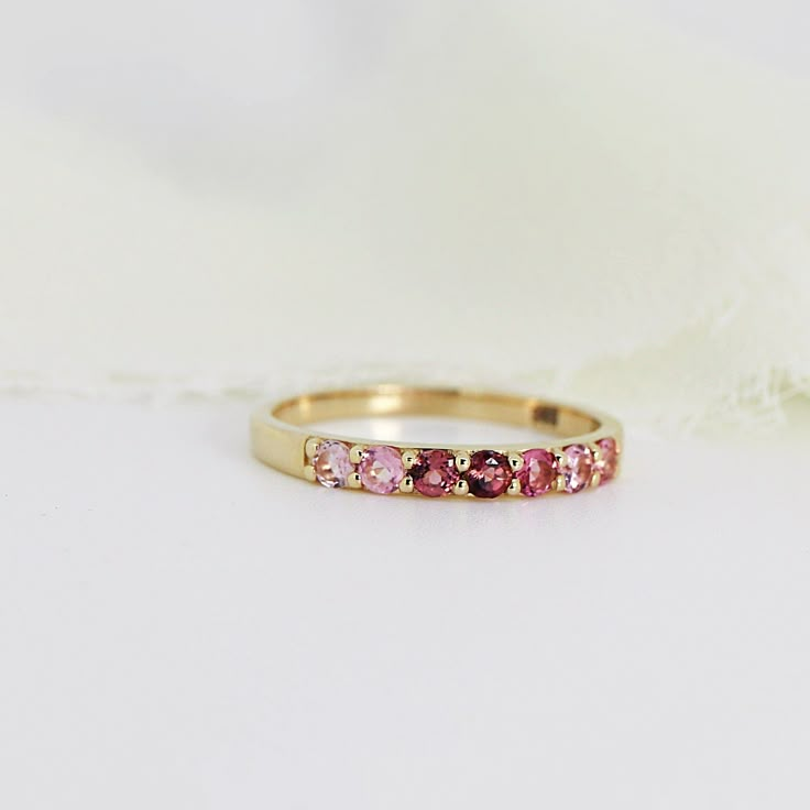 Ombre Ring Band in 14k Solid Gold, Half Eternity Gradient Pink Tourmaline Ring, Colorful Gemstone Ring, Anniversary Gift, October Birthstone . DETAILS ABOUT THE RING, MATERIALS AND STONE Ring Band: 14K YELLOW GOLD Ring Band size: 2.54mm wide band Gemstones: 2mm natural pink gradient tourmalines. Pave setting. 2mm tall from finger. Total 7 pink tourmalines. Matching hoop earrings are available from this link; https://www.etsy.com/listing/1164157904/pink-tourmaline-hoop-earrings-14k-gold? SIZE : P Pink Gold Stackable Rings In Fine Jewelry Style, Pink Gold Stackable Rings Fine Jewelry, Pink Gold Stackable Fine Jewelry Rings, Fine Jewelry 14k Gold Half Eternity Birthstone Ring, 14k Gold Half Eternity Birthstone Ring, Pink Half Eternity Ring With Round Cut, 14k Gold Multi-stone Stackable Rings, Pink Gold Stackable Rings For Anniversary, Stackable Pink Gold Rings For Anniversary