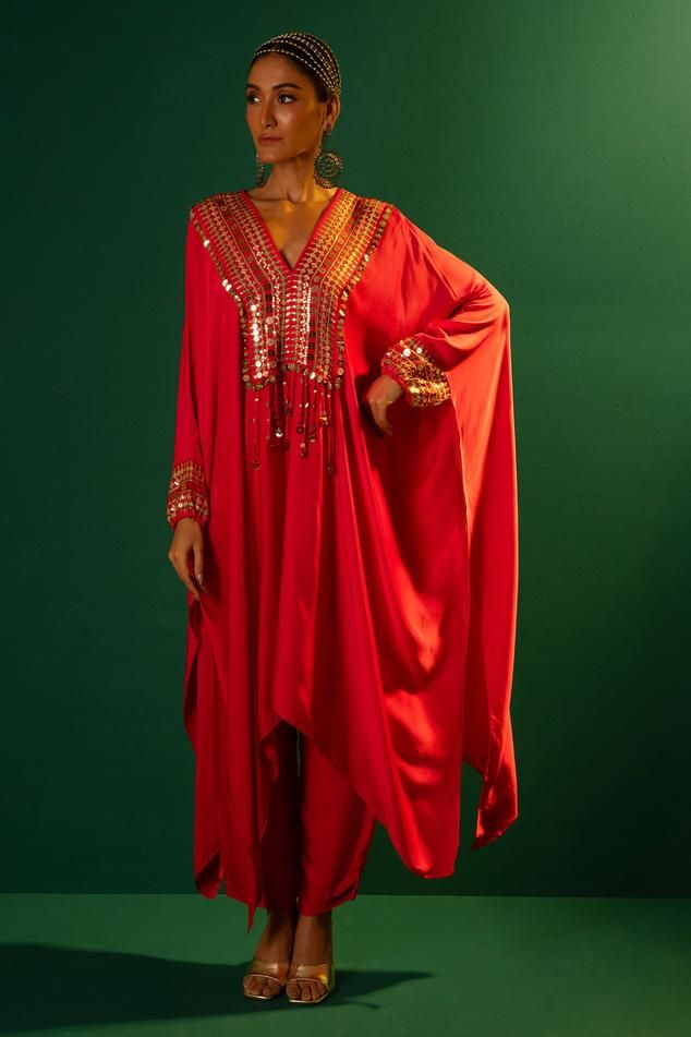 Red satin kaftan with mirror and sequins hand embroidery. Comes with pant.
Components: 2
Pattern: Hand embroidered
Type Of Work: Mirror, Sequins
Neckline: V Neck
Sleeve Type: Flared Sleeves
Fabric: Satin
Color: Red
Other Details: 
Fringes detailing on kaftan
Occasion: Sangeet - Aza Fashions Bollywood Style Festive Abaya For Party, Festive Bollywood Style Abaya For Party, Bollywood Style Festive Party Abaya, Festive Bollywood Party Abaya, Bollywood Style Embellished Abaya With Traditional Drape, Bollywood Style Party Abaya With Traditional Drape, Festive Embellished Abaya With Traditional Drape, Festive Embellished Traditional Drape Abaya, Red Embellished Kaftan With Traditional Drape