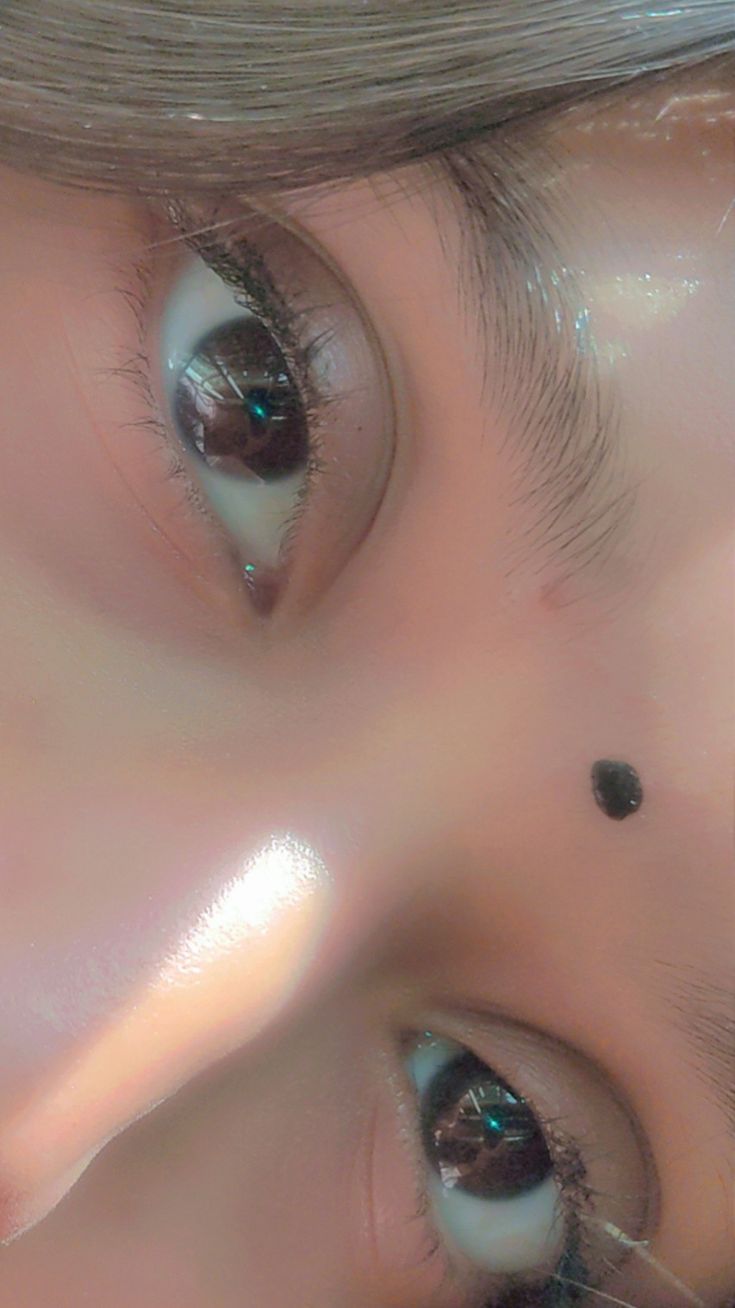 the eyes of a doll are shown with long eyelashes and black dots on their lashes