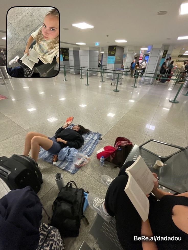 people are sitting on the floor in an airport