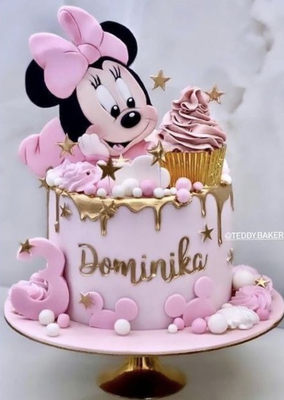 a pink and gold minnie mouse birthday cake