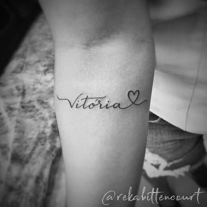 a woman's arm with the word victoria written in cursive writing on it