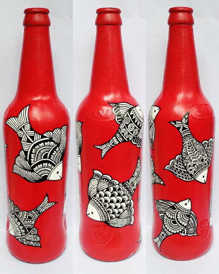 three red bottles with black and white designs on them