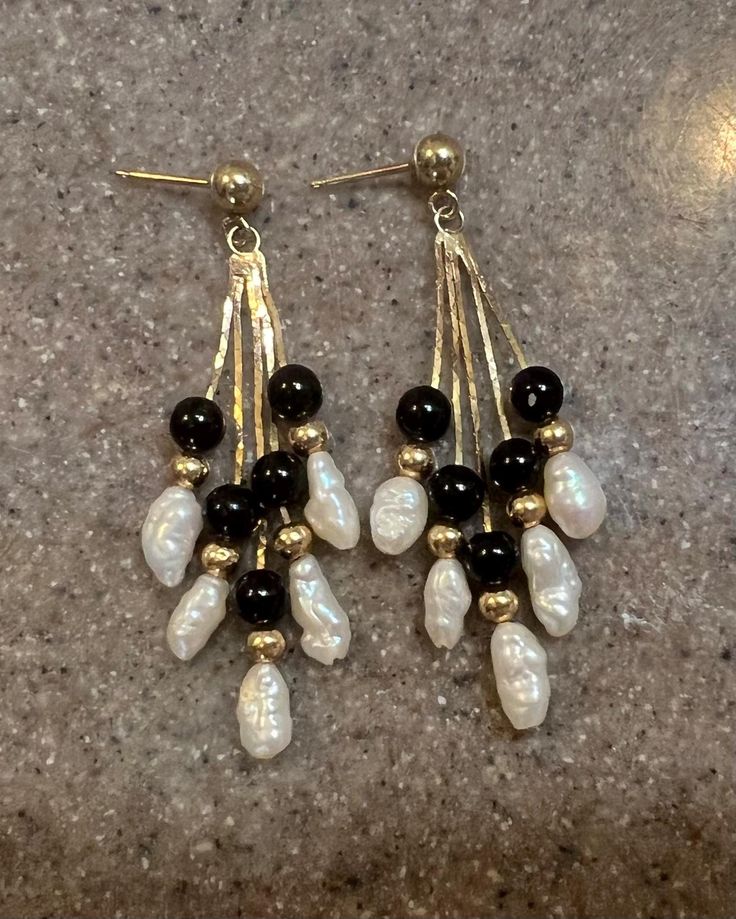 Vintage 14K Yellow Gold Pearl Onyx Dangle Earrings Beautiful pair of 14k yellow gold dangle earrings that each have 5 pearls and 5 round onyx, separated by gold beads.  Marked 14K on the posts. The backs fit well but are not solid gold. Measures- 1.75" long  Weighs- 2.7 Grams (without the backs) In good vintage condition Will ship in a gift box. Stock #E2907 As with all jewelers, I do enlarge pictures of the jewelry.  This is to your advantage, so you can see all details more clearly.  I do prov Elegant Black Beaded Chandelier Earrings, Elegant Black Chandelier Earrings With Dangling Beads, Classic Black Pearl Drop Earrings, Black Pearl Drop Earrings For Formal Occasions, Black Pearl Drop Earrings For Formal Events, Classic Black Pearl Drop Jewelry, Black Dangle Pearl Drop Earrings, Black Pearl Drop Dangle Earrings, Black Pearl Drop Earrings For Anniversary