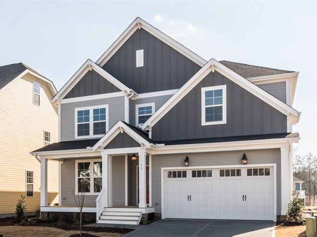 two story house with white trim and gray siding