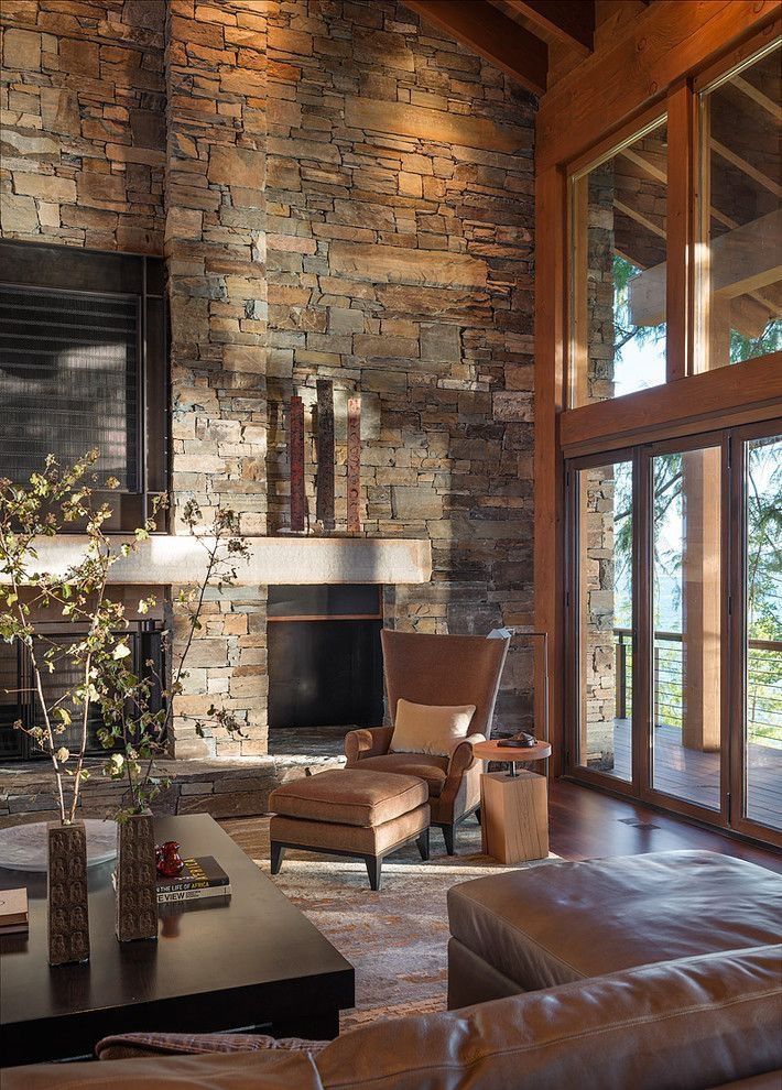 a living room with couches, chairs and a fireplace