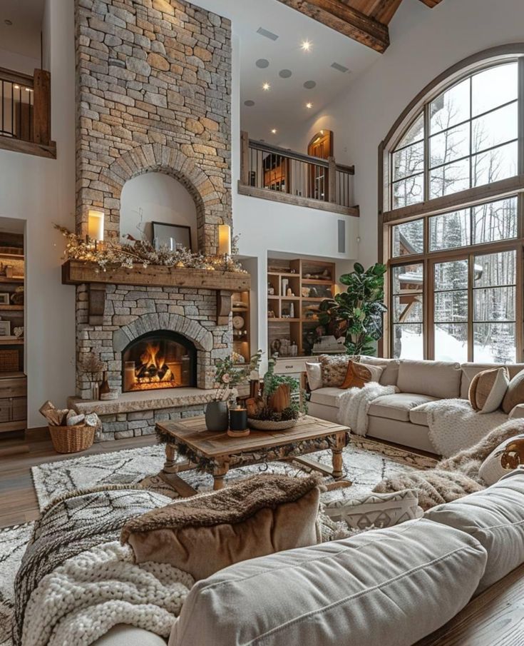 a living room filled with lots of furniture and a fire place in the middle of it