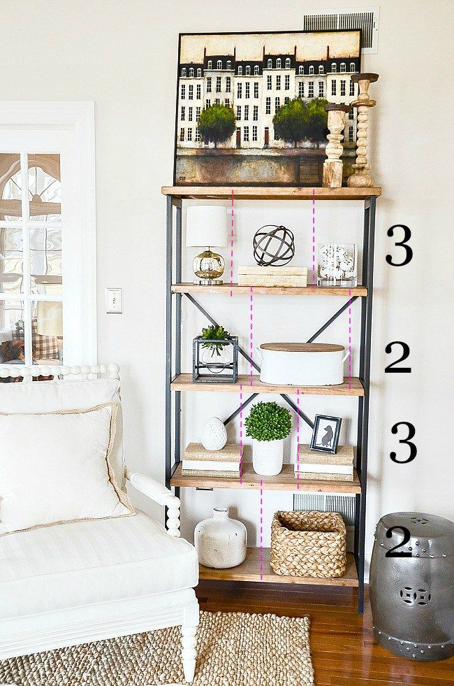 a living room filled with furniture and lots of plants on top of bookshelves