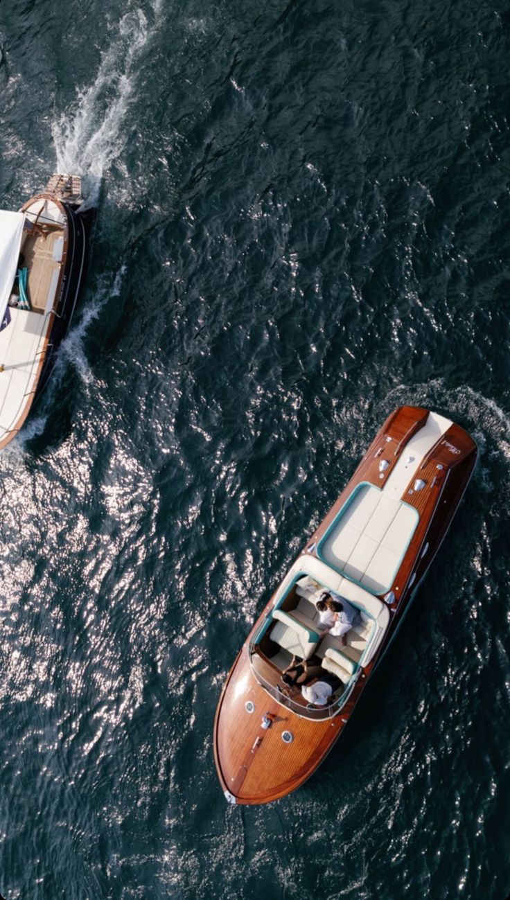 two small boats in the water near each other