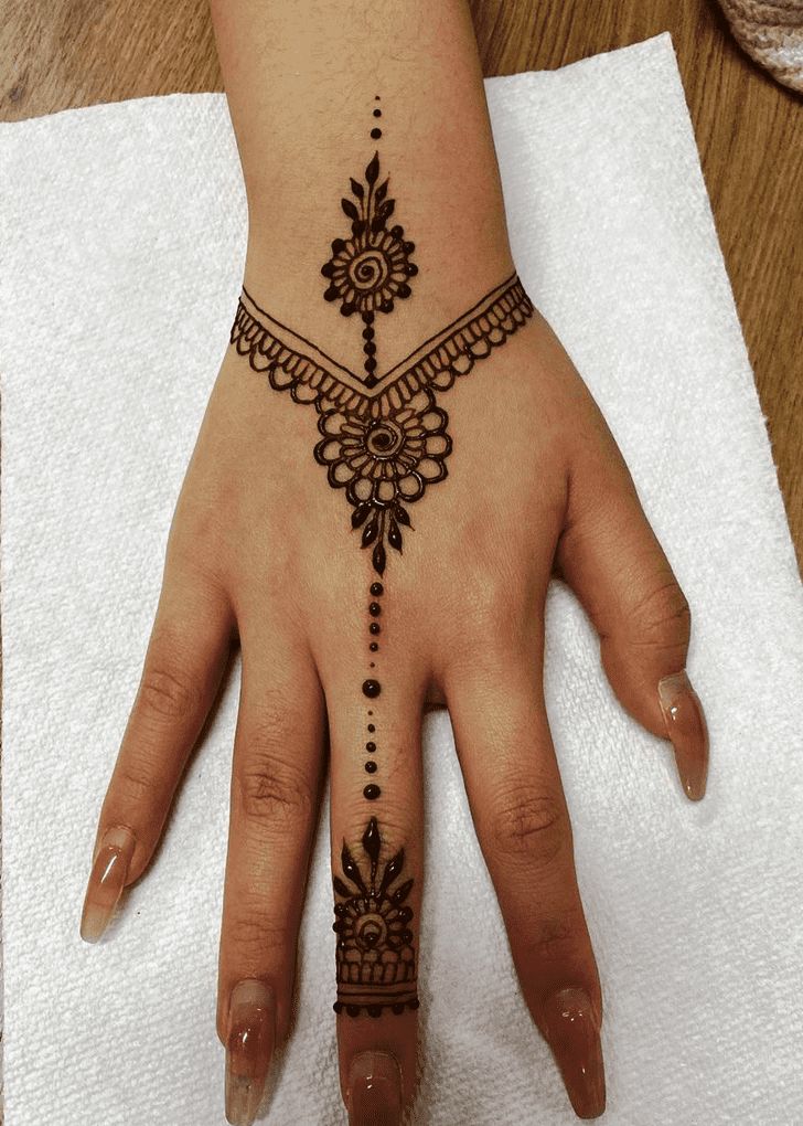 a woman's hand with a henna tattoo on it