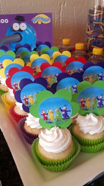 there are cupcakes on the table with frosting and decorations for each one