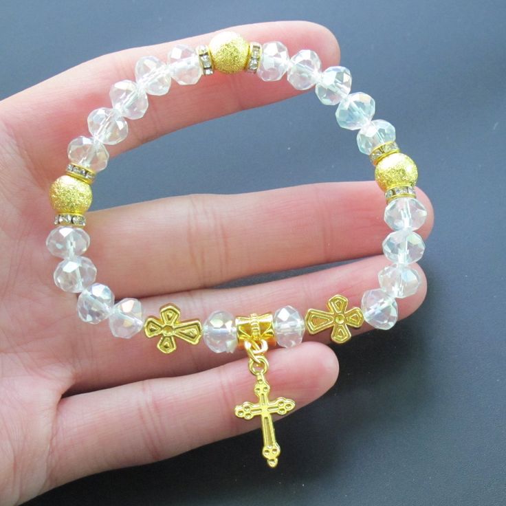 12 PCS Crystal stretch bracelets with gold metal cross charms for first communion, baptism, christening, wedding shower and memories party favor. The high-quality bracelet is made of Crystal clear beads and gold metal charm. 12 Pcs First Communion bracelets for guests. The high-quality bracelets are made of Crystal clear beads and silver metal charm An excellent favor for your guests. A special gift they are sure to cherish. Handmade beaded crystal stretch bracelet with silver cross charms. one Spiritual Cross Rosary Bracelet For Baptism, Spiritual Gold Crystal Bracelet, Hypoallergenic, Adjustable Gold Rosary Bracelet For Baptism, Gold Cross Bracelet For Baptism, Gold Rosary Bracelet For Baptism, Gold Spiritual Rosary Bracelet For Baptism, Spiritual Rosary Bracelet With Cross For First Communion, Spiritual Cross Bracelets For Baptism, Spiritual Cross Bracelet For First Communion