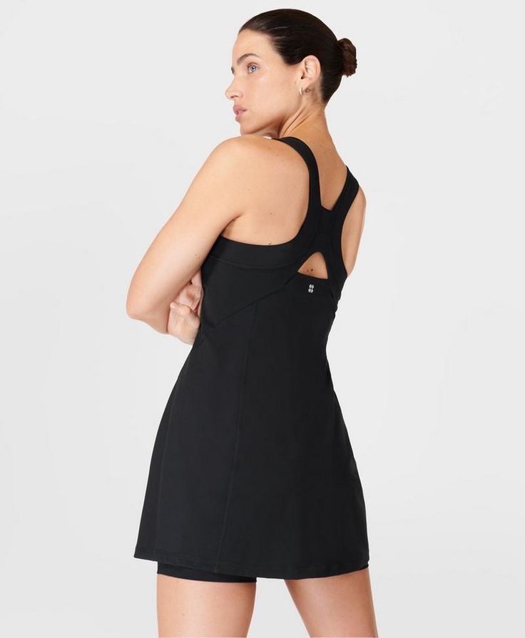 Our sporty new workout dress for styling out the sweatiest of sessions. Sweat-wicking Power Pro fabric is breathable and stretchy with a matte finish. Slim, body-skimming fit with contrasting panels and a flattering racerback. Supportive inner shorts with slip pocket. In-built bra with removable pads. Length: 77.5cm / 31". Model wears size S and is 178cm/5'10" tall. Style Code: SB9287BColour: Black Sleek Activewear With Built-in Bra For Sports, Sporty Tennis Activewear With Built-in Bra, Sporty Mini Dress With Built-in Bra For Workout, Fitted Racerback Tennis Dress, Functional Fitted Activewear With Mesh Back, Fitted Functional Activewear With Mesh Back, Workout Dresses With Built-in Bra And Racerback, Sleek Fitted Activewear For Sports, Fitted Racerback Tennis Dress For Sports