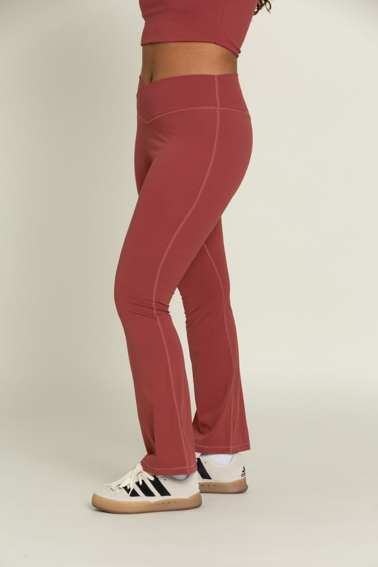 Feel effortlessly on trend for your workout class or a day on-the-go with our Pale Red Flare Yoga Pants. The crossover waistband provides an elevated look, offering you both security and comfort for any activity. The flare leg creates an unrestricted yet chic design. Pair with our Pale Red Square Neck Long Sleeve Top for the perfect set. Moisture-wicking Wide Leg Activewear For Sports, Sporty Moisture-wicking Wide Leg Activewear, 4-way Stretch Wide Leg Activewear For Workout, Sporty Wide Leg Elastane Activewear, Red Athleisure Bottoms With Elastic Waistband, Red Elastane Workout Pants, Sporty Mid-rise Yoga Pants With Contoured Waistband, Comfort Stretch Wide Leg Activewear For Sports, Red Workout Pants With Elastane