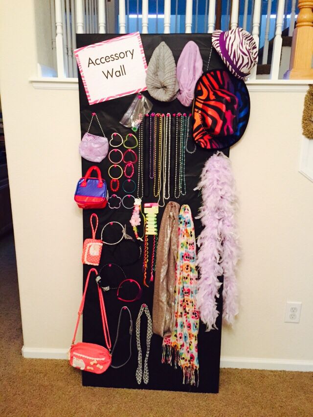 a black board with lots of items hanging on it's sides and a sign that says accessory wall