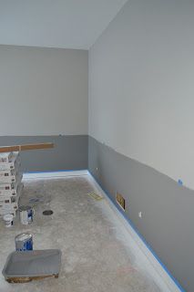 an empty room with gray walls and blue tape