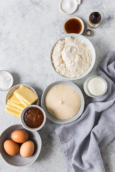 an assortment of ingredients on a table including eggs, flour and butter