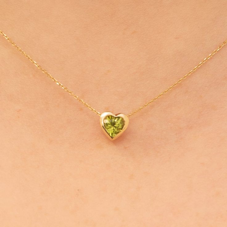 Ashly Follow your heart and it will lead you to our 14k gold necklaces. This red heart necklace has a beautiful oval cut and would make the perfect gift for her. Available in Yellow Gold, White Gold, and Rose Gold. - Handmade- Solid Gold- Natural Peridot- Heart Size: 7.5 mm- Total Peridot Carat Weight: .60 ctw All pieces come beautifully boxed in suede pouches you can always use (which really comes in handy when traveling!) Peridot Gold Necklace, Peridot Necklace Gold, Peridot Aesthetic, August Birthdays, Red Heart Necklace, Yellow Pearl, Peridot Jewelry, Peridot Necklace, Solid Gold Necklace