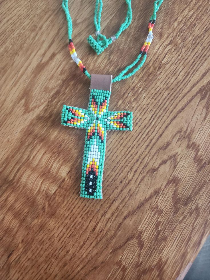 a beaded cross on a wooden table