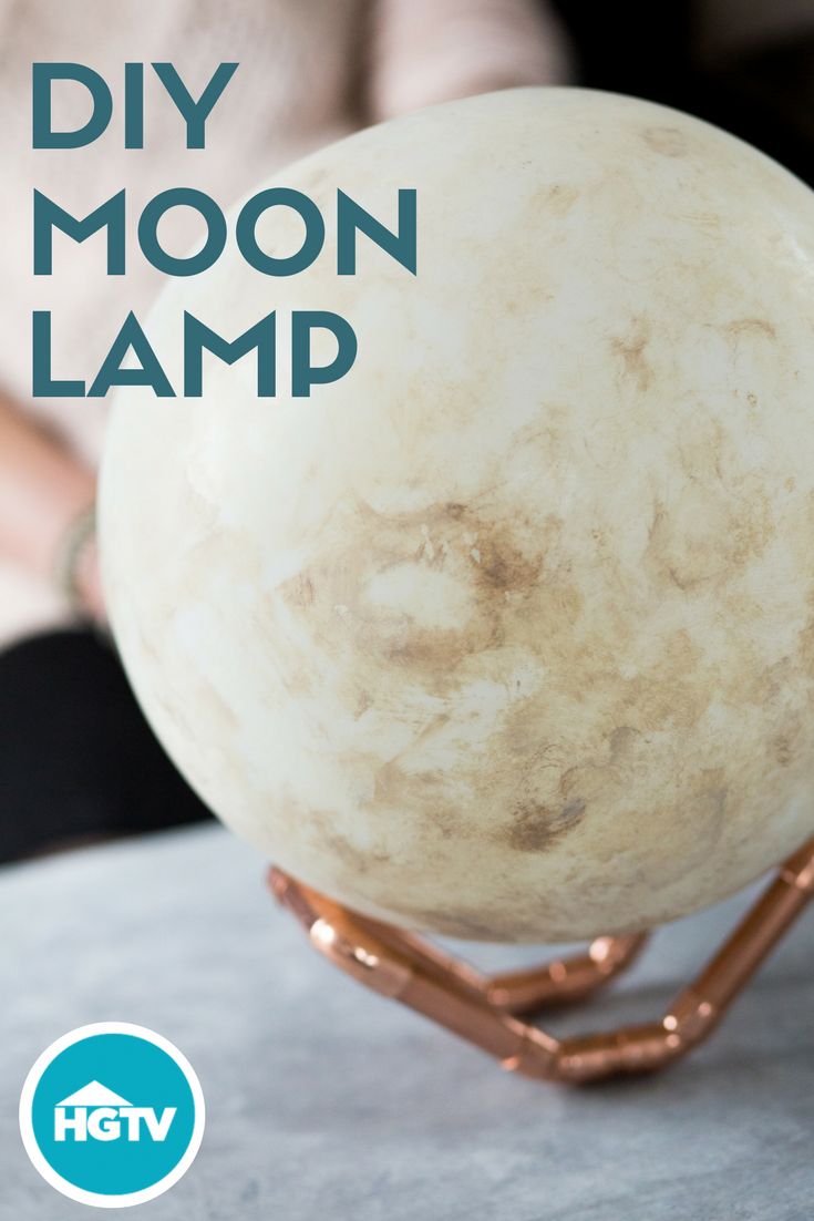 a white ball sitting on top of a metal stand with the words diy moon lamp above it