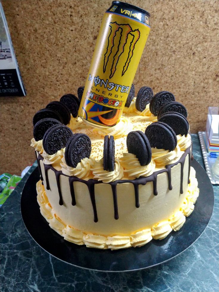 a cake with oreo cookies and an energy drink on top