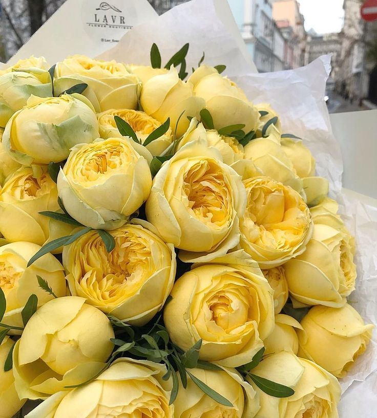 a bouquet of yellow flowers sitting on top of a table