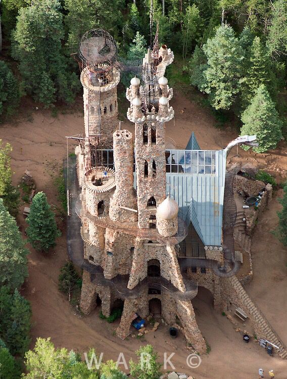 an aerial view of a castle in the woods