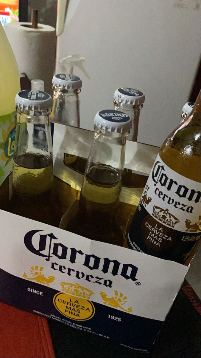 several bottles of corona beer sitting on top of a table