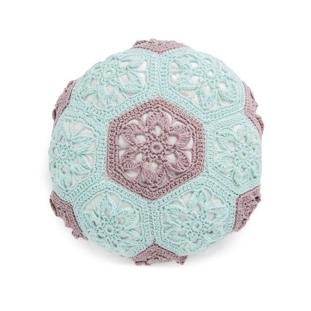 a crocheted round pillow on a white background